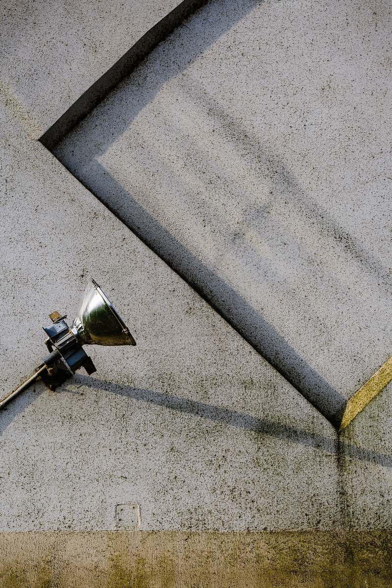 spot light gray stainless steel lamp on gray concrete pavement wall